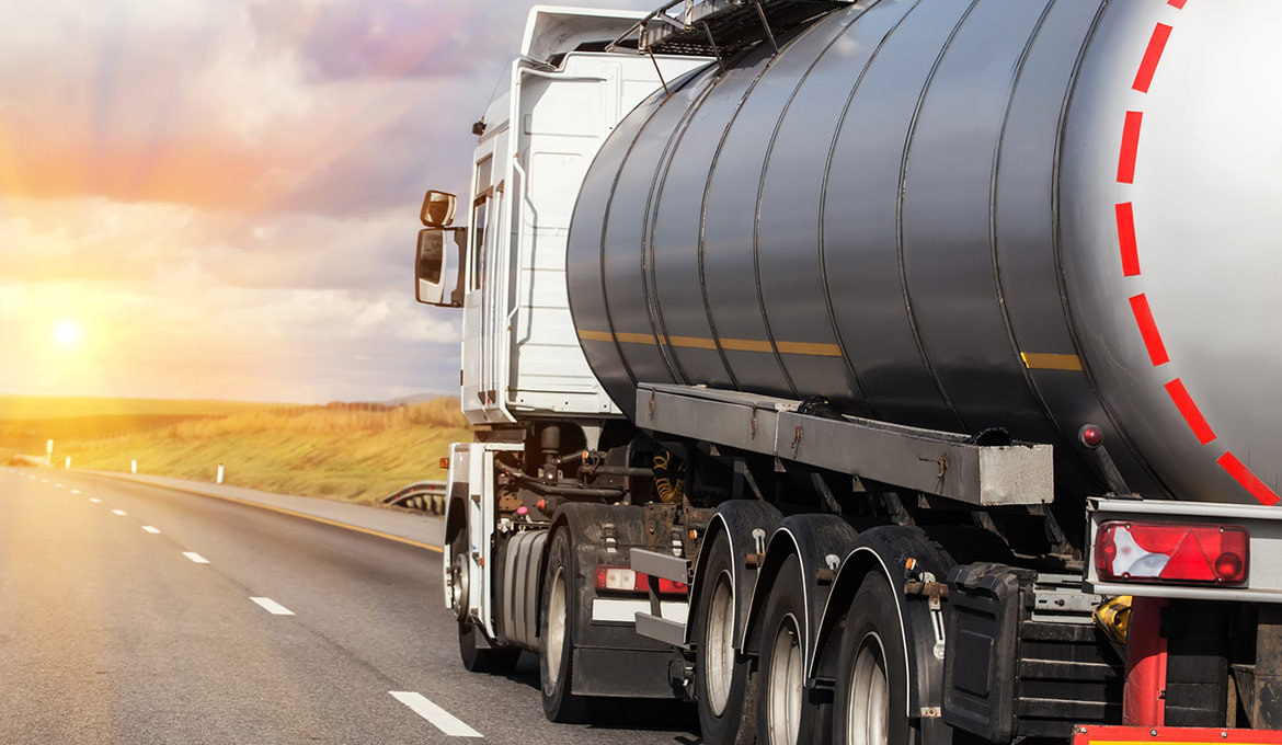 Large tanker delivering fuel and traveling on the interstate.