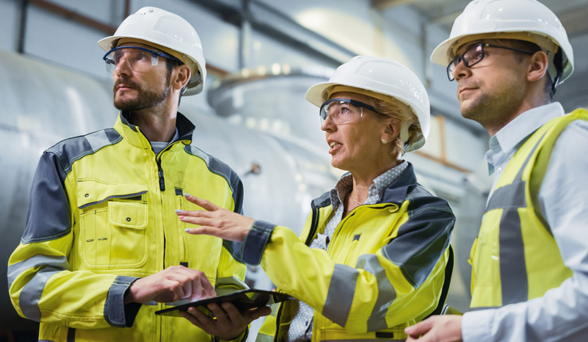Two men and a woman conducting a facility walkthrough inspection.