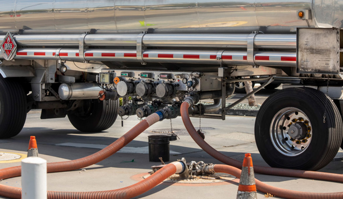 Large tanker delivering fuel to an underground tank.