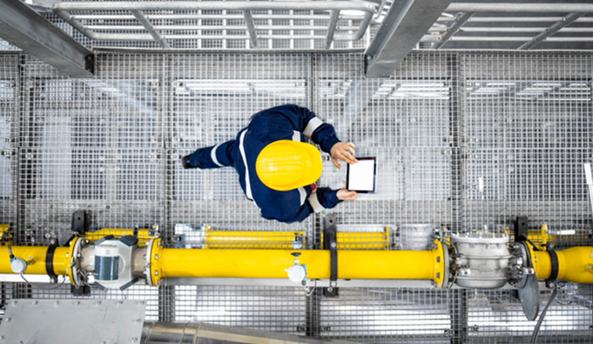 Top-down view of a facility worker walking through a large facility conducting a digital inspection.