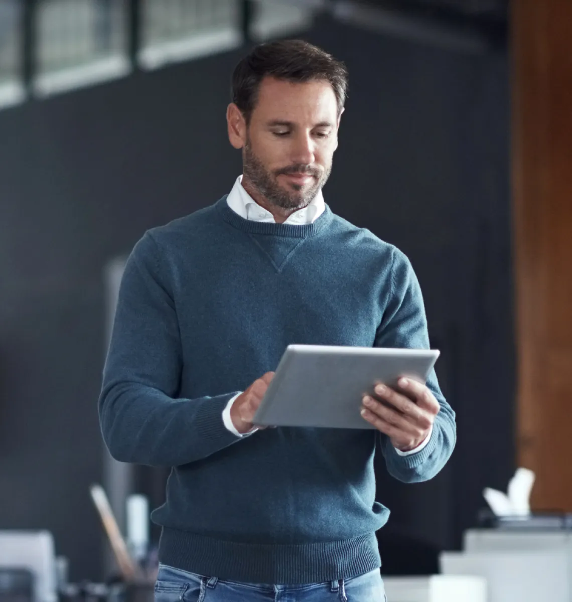 Business man using a tablet to access Titan Cloud software.