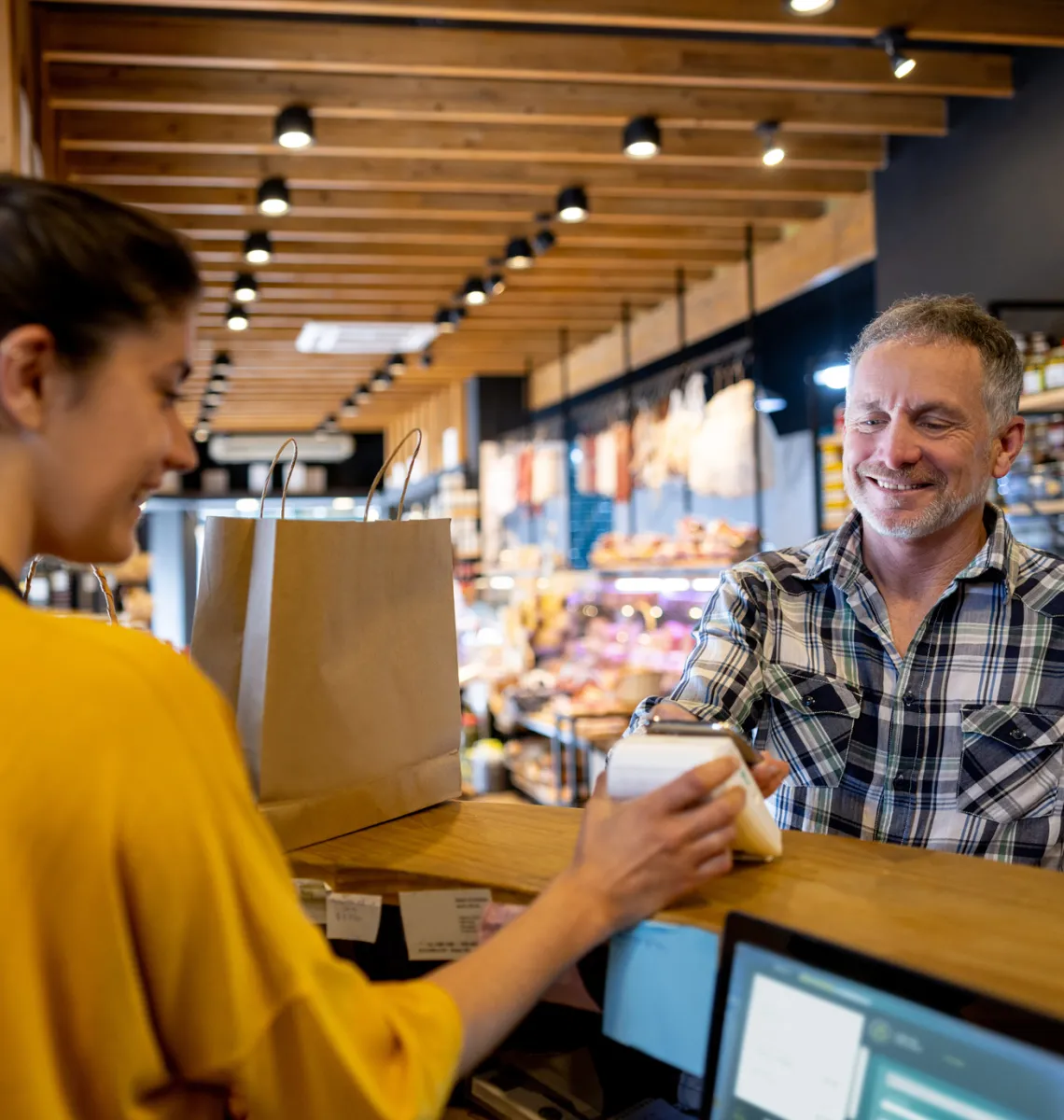 Man checking out using his mobile phone at the convenience store, demonstrating smooth customer experiences.