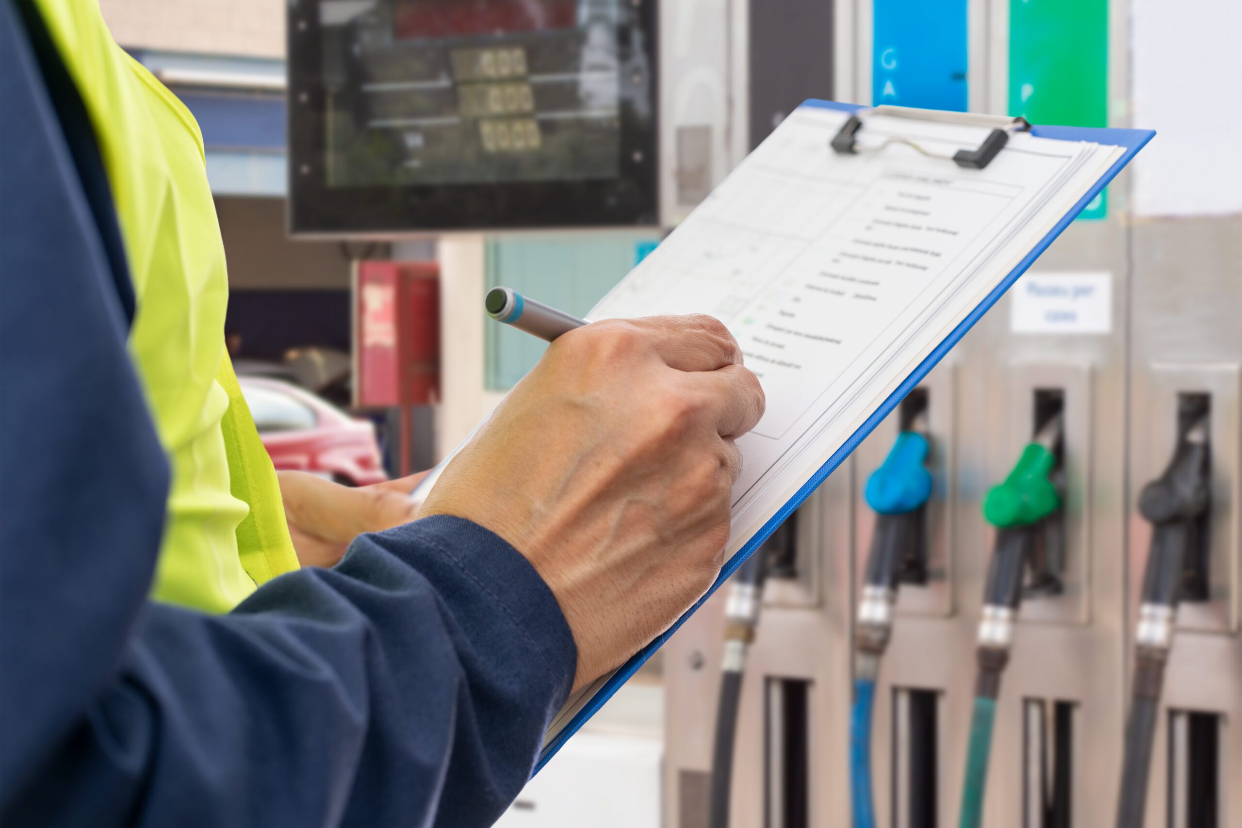 Fuel-site professional completing an inspection checklist