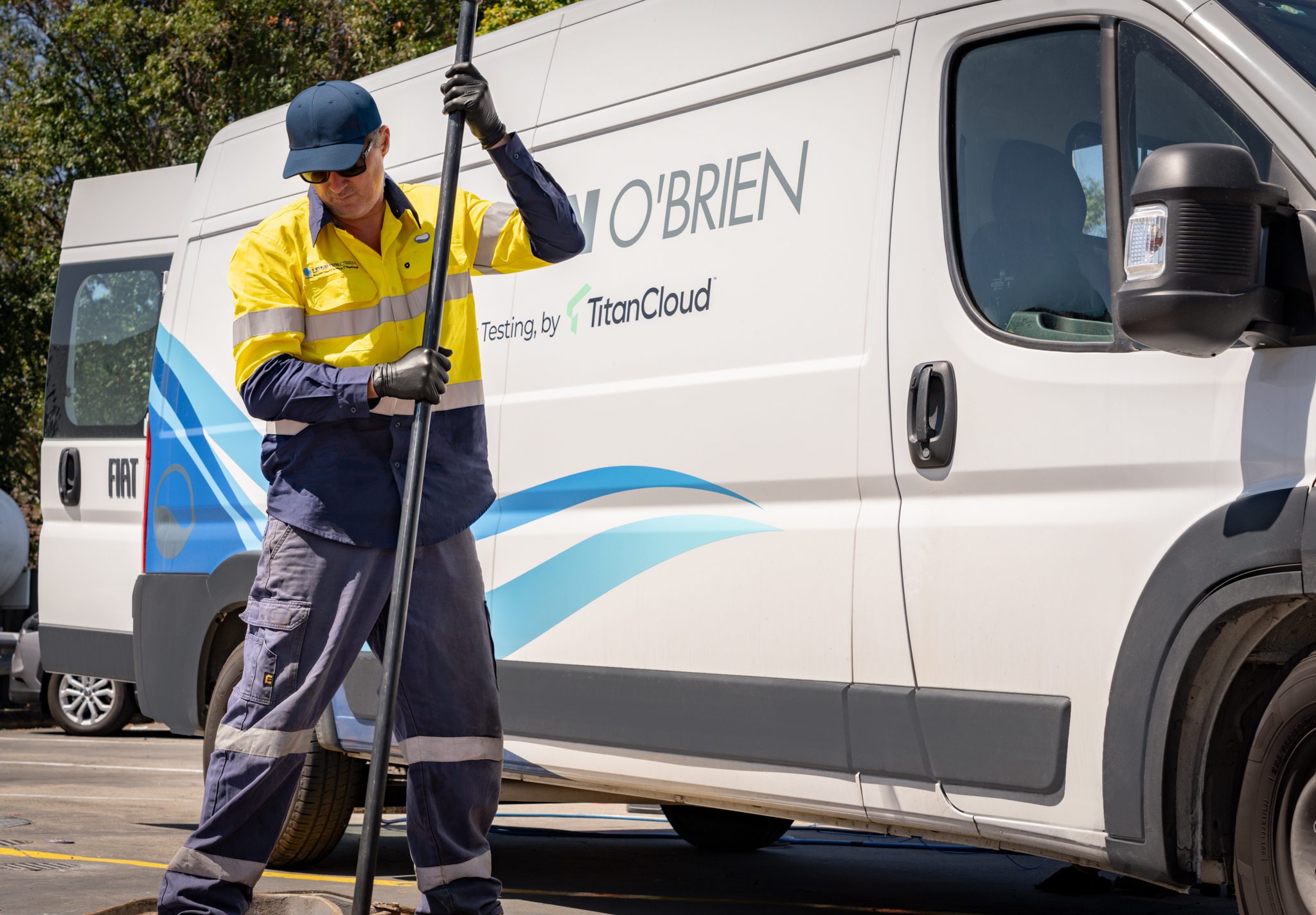 Testing technician working beside a Titan Cloud-branded service van